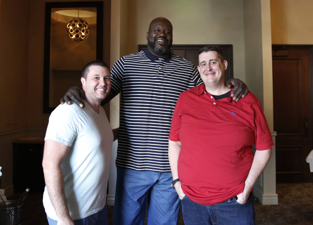 Former NBA player and owner of "Big Chicken" restaurant Shaquille O'Neil, center, pos ...