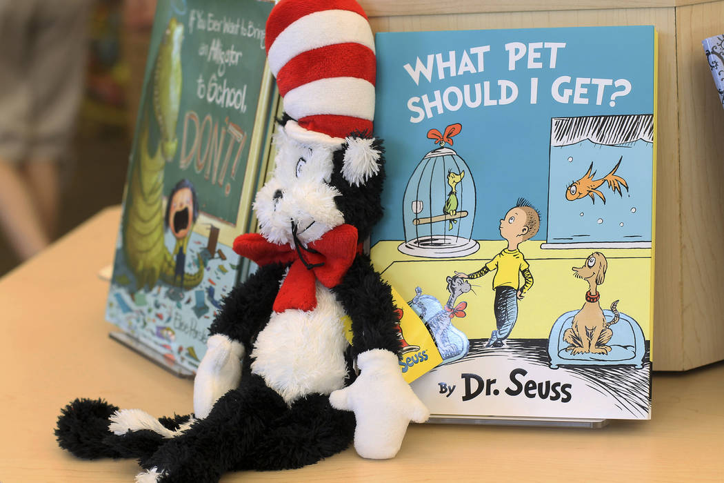 A plush “Cat in the Hat” toy is displayed next to “What Pet Should I Get?” (AP Photo/Holly Ramer)