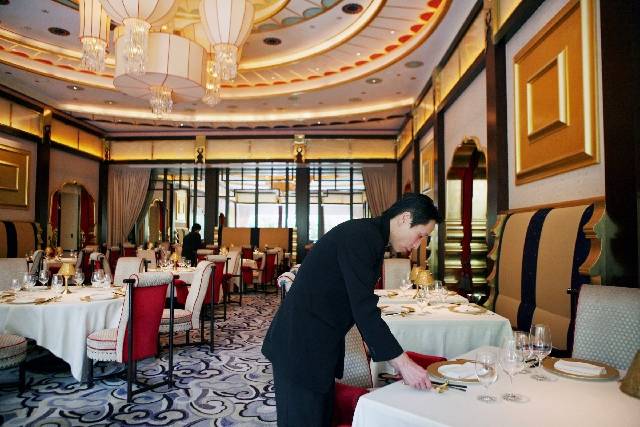 Server Roy Dong sets tables before the opening of Wing Lei at Wynn Las Vegas on the Las Vegas Strip. (Las Vegas Review-Journal)