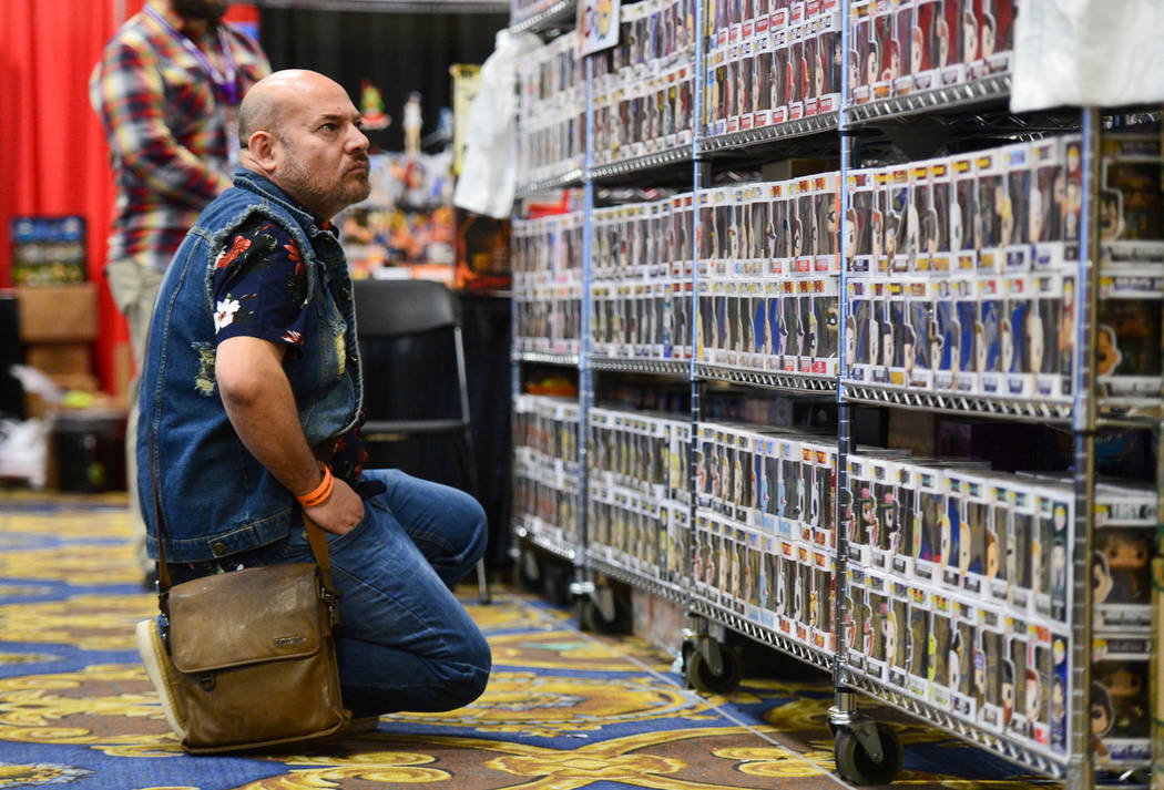 Joseph Aguilera scans rows upon rows of Pop! figurines at Las Vegas Toy and Comic Convention at the Westgate Resort and Casino in Las Vegas, on Sunday, March 3, 2019. Pop! makes figurines of chara ...
