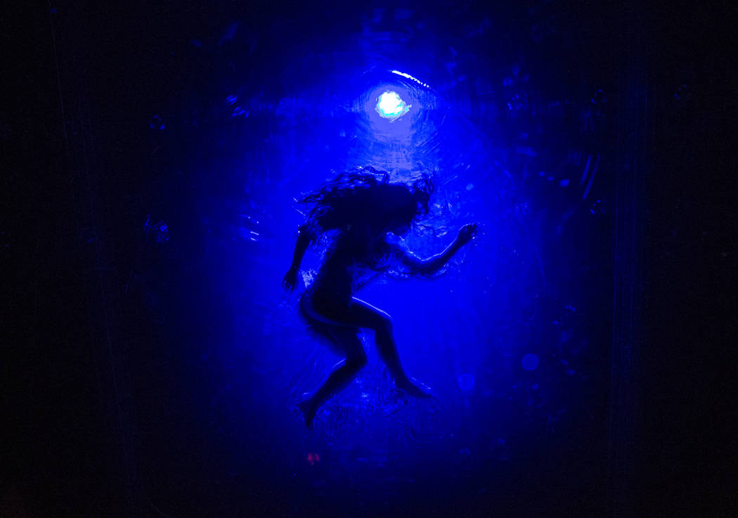 A cast members in "Fuerza Bruta" performs on a mylar suspended pool as part of a medi ...