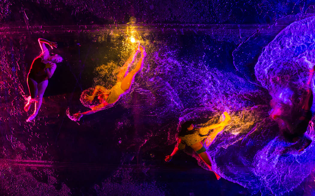Cast members in "Fuerza Bruta" perform on a mylar suspended pool as part of a media p ...