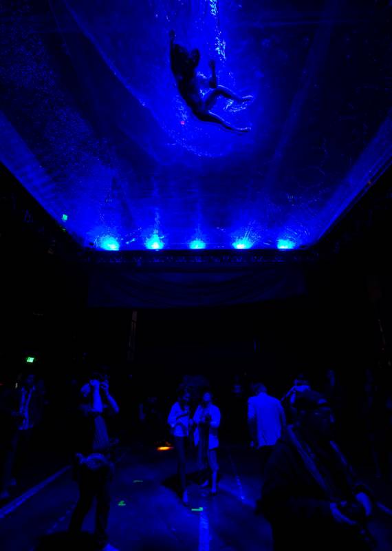 A cast members in "Fuerza Bruta" performs on a mylar suspended pool as part of a medi ...