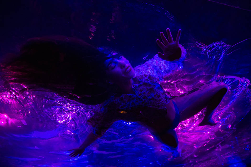 A cast members in "Fuerza Bruta" performs on a mylar suspended pool as part of a medi ...