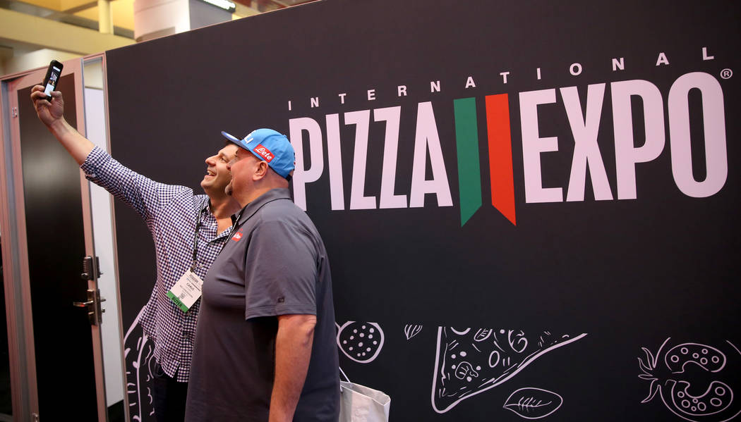 Carlo Luciano of Wayne, Pennsylvania, left, and Lorenzo Colella of Brewster, New York, take a selfie at the International Pizza Expo at the Las Vegas Convention Center Tuesday, March 5, 2019. (K.M ...
