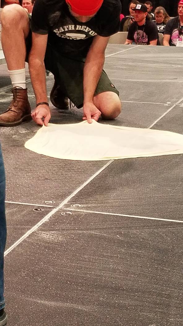 A Largest Stretch contestant smooths his dough onto the floor at the International Pizza Expo on Wednesday, March 6, 2019, at the Las Vegas Convention Center. Heidi Knapp Rinella/Las Vegas Review- ...