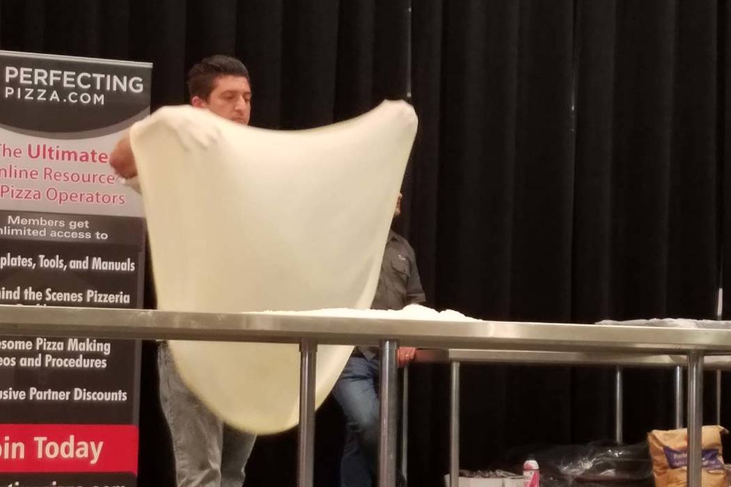Anthony Scillieri of Wynn Resorts competes in the Largest Stretch contest at the International Pizza Expo on Wednesday, March 6, 2019, at the Las Vegas Convention Center. Heidi Knapp Rinella/Las V ...