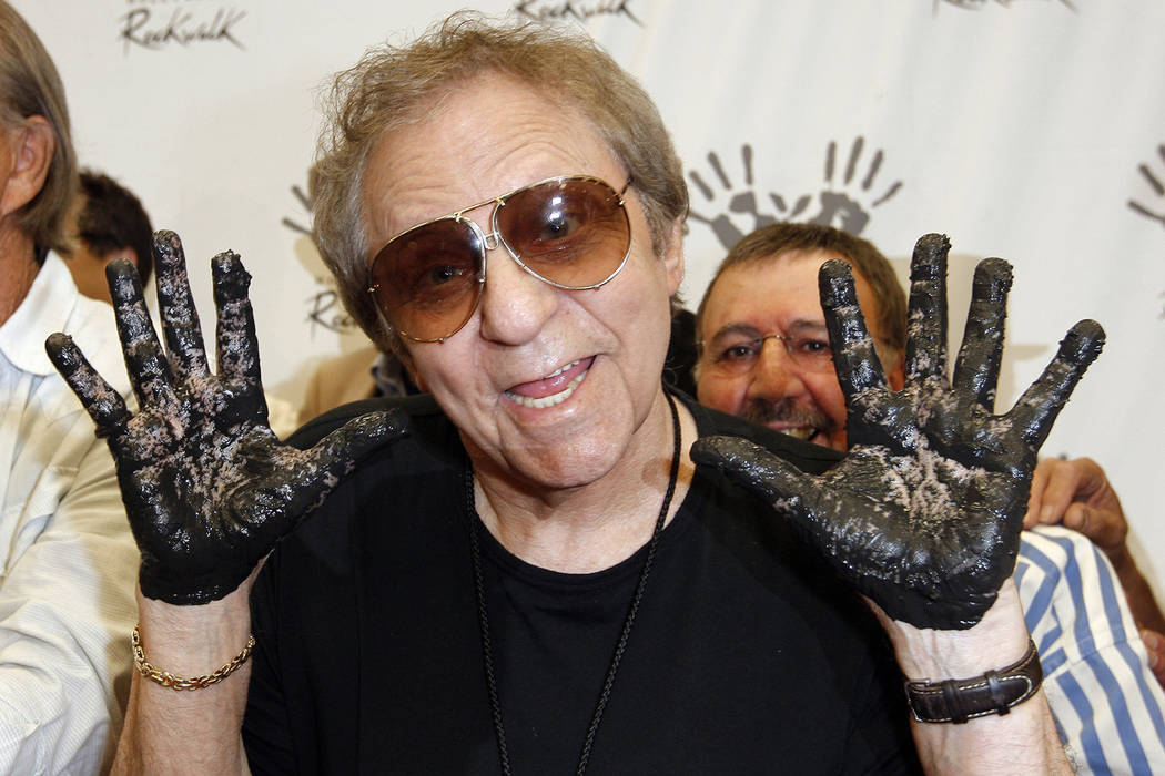In this June 25, 2008, file photo, Hal Blaine holds up his hands covered in cement after placing them in wet cement with Don Randi and Glen Campbell, representing The Wrecking Crew following an in ...