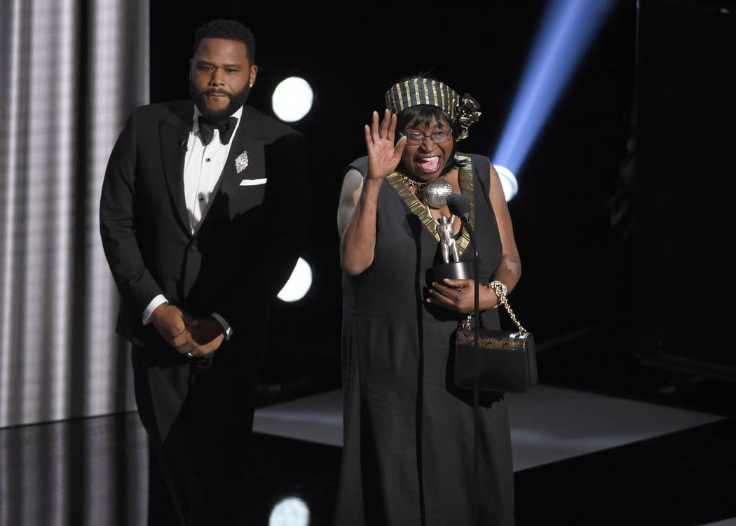 Anthony Anderson, left, accepts the award for outstanding actor in a comedy series for "bl ...
