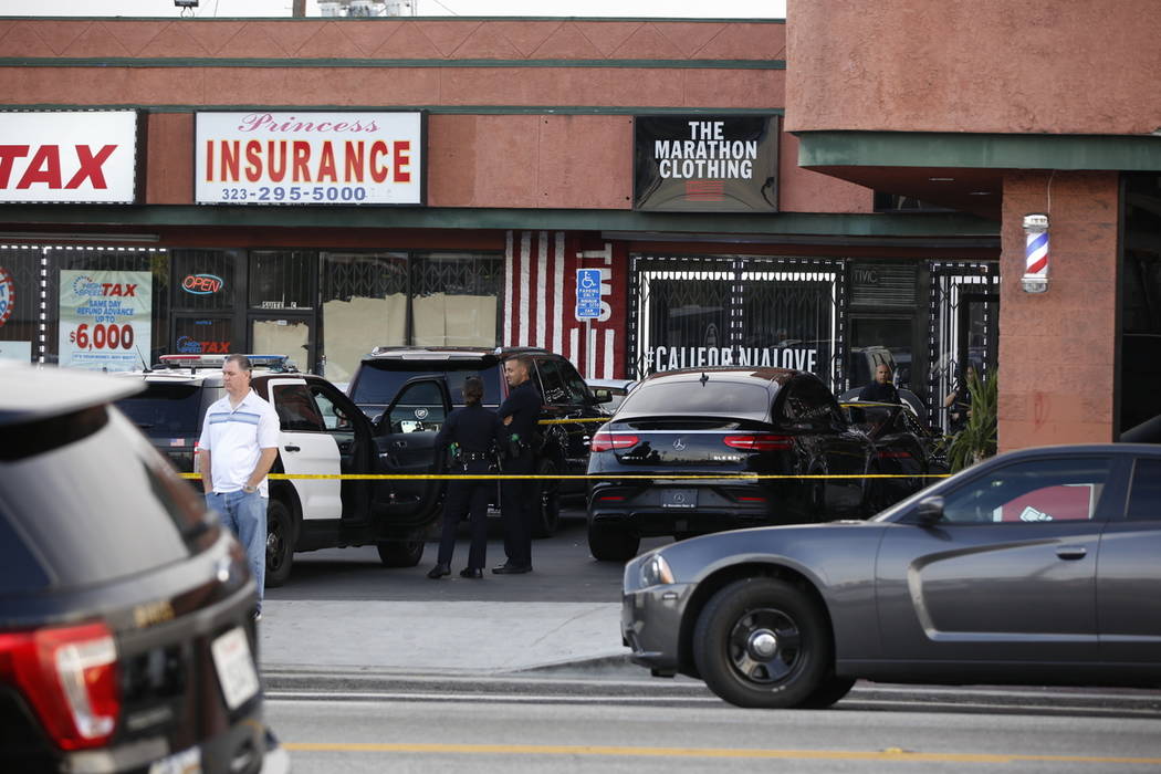 Los Angeles Police officers guard the Marathon Clothing store of rapper Nipsey Hussle after a s ...