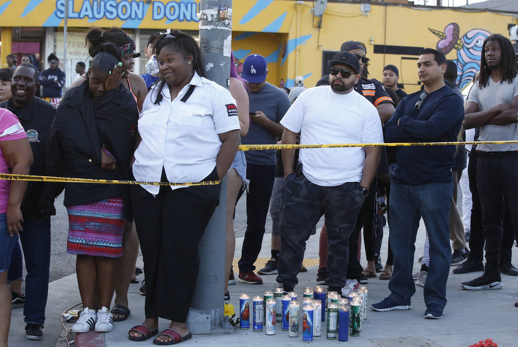 People gather around the Marathon Clothing Co. store of rapper Nipsey Hussle after a shooting i ...