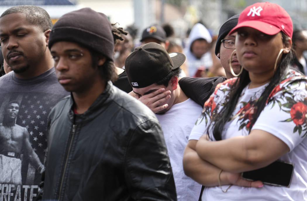 Fans of rapper Nipsey Hussle mourn at a makeshift memorial in the parking lot of The Marathon C ...