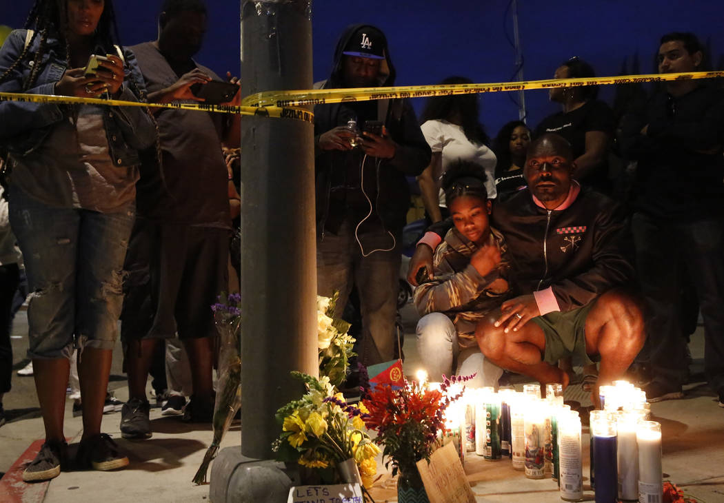 Haitian-French actor Jimmy Jean-Louis and his daughter Jasmin, 16, gather around candles set up ...