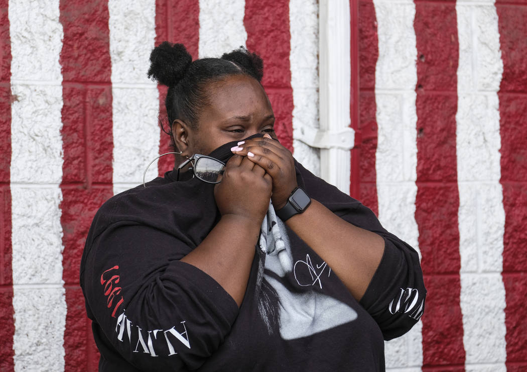 Sydney Flenour cries as she mourns rapper Nipsey Hussle at a makeshift memorial in the parking ...