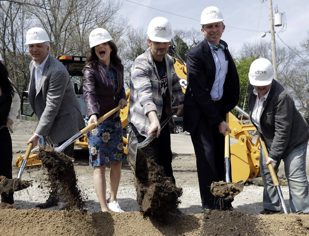 Country music star Brad Paisley, center, and his wife, actress Kimberly Williams-Paisley, secon ...