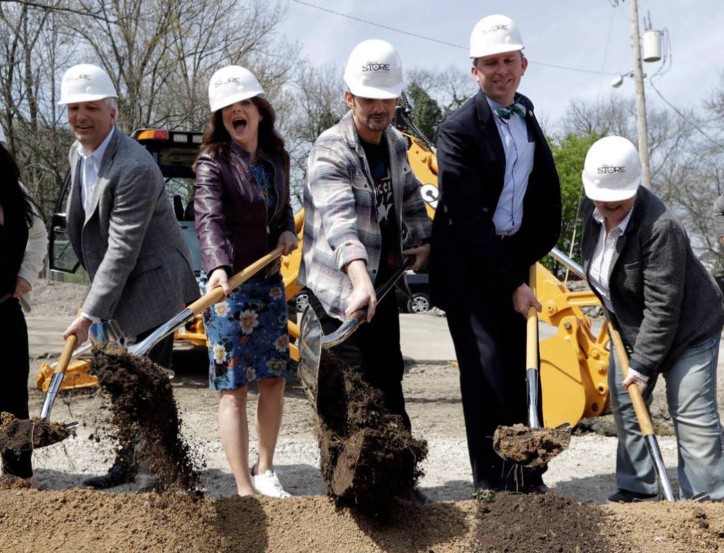 Country music star Brad Paisley, center, and his wife, actress Kimberly Williams-Paisley, secon ...