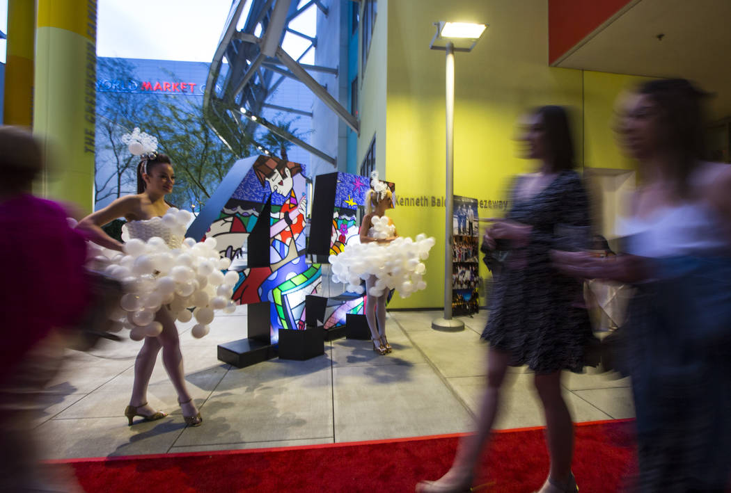 Michelle Bell, left, and Lucie May model dresses by balloon artist Ronnie Johnson during Bubble ...