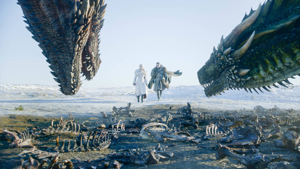 This image released by HBO shows Emilia Clarke, left, and Kit Harington in a scene from " ...
