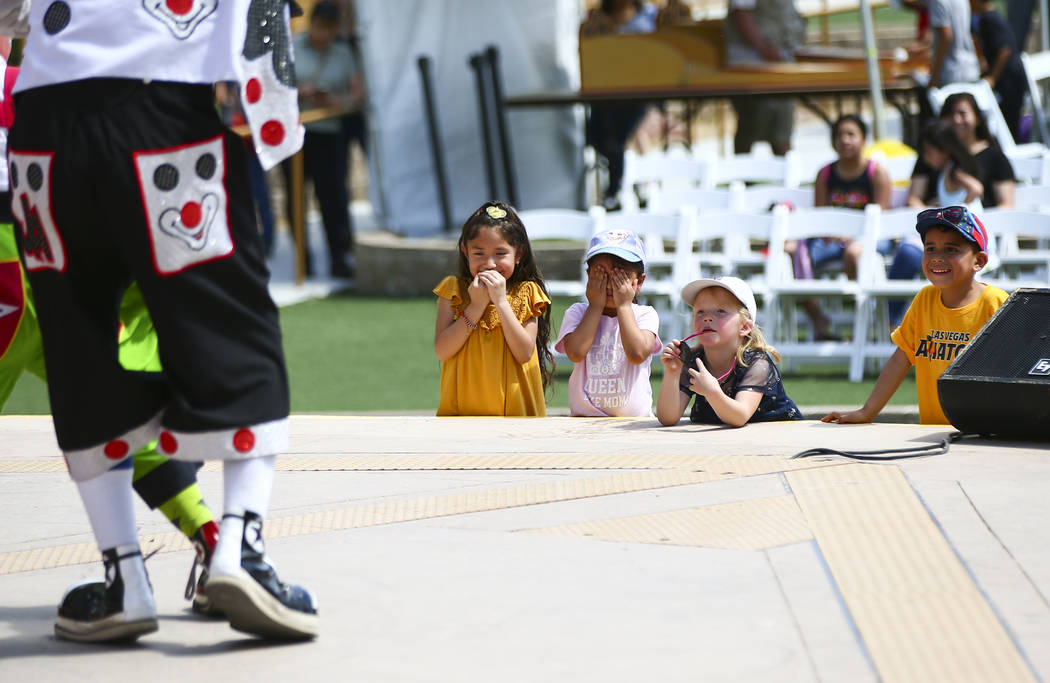 Children watch as Chirolito and Bobofito perform during the 10th annual Dia del Nino event at t ...
