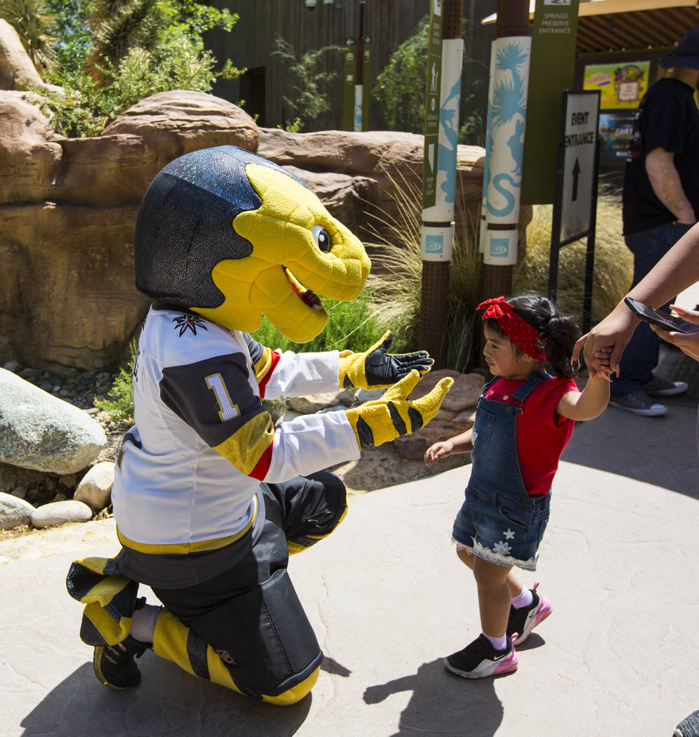 Two-year-old Noemi Ha, of Las Vegas, greets Golden Knights mascot Chance during the 10th annual ...