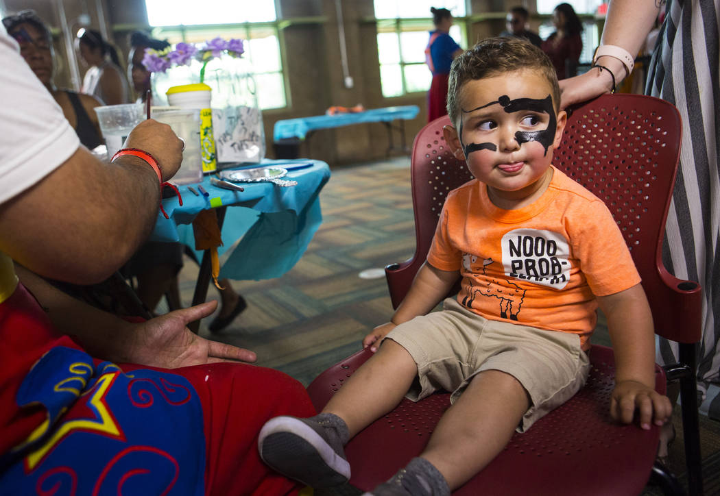 Gabriel Fernandez, 2, looks on while getting his face painted during the 10th annual Dia del Ni ...