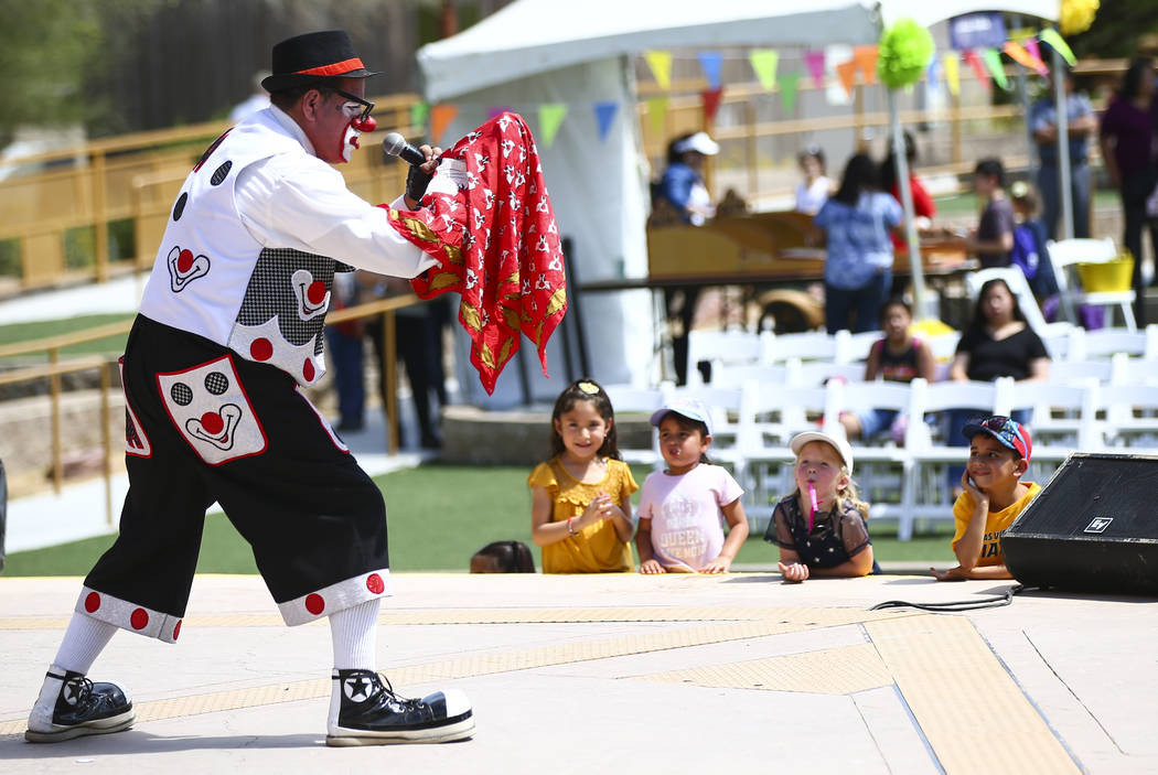 Children watch as Chirolito the clown performs during the 10th annual Dia del Nino event at the ...