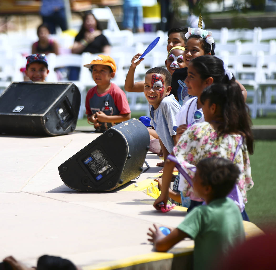 Children watch a clown performance during the 10th annual Dia del Nino event at the Springs Pre ...