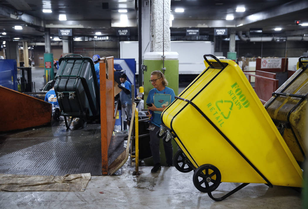 In this March 26, 2019, photo, people work in a recycling area in the back of the house at the ...