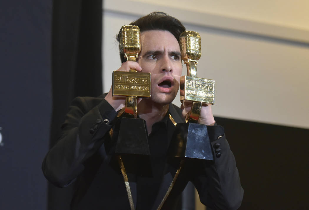 Brendon Urie, of Panic! at the Disco, poses in the press room with the awards for top rock albu ...