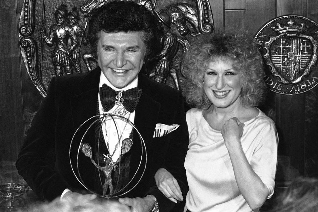 Bette Midler, right, accepts the Entertainer of the Year award at the Conference of Personal Ma ...