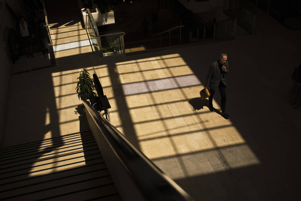 A festival goer walks through the Palais des festivals during for the 72nd international film f ...