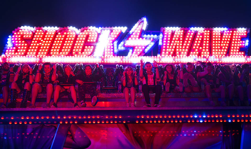 Concert goers ride the Shock Wave during day two of Electric Daisy Carnival at Las Vegas Motor ...
