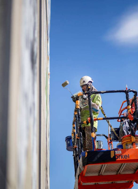 French painter Mantra works on his mural in preparation for Life is Beautiful music festival in ...