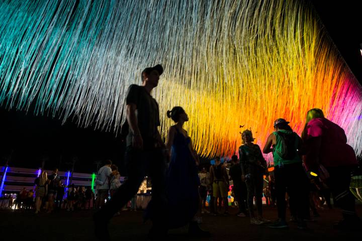 Attendees pass by an art installation by Hot Tea during the first day of the Life is Beautiful ...
