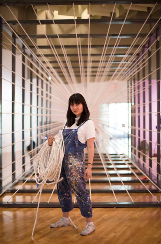 Amanda Phingbodhipakkiya, a neuroscientist-turned-artist, stands in front of one of her install ...