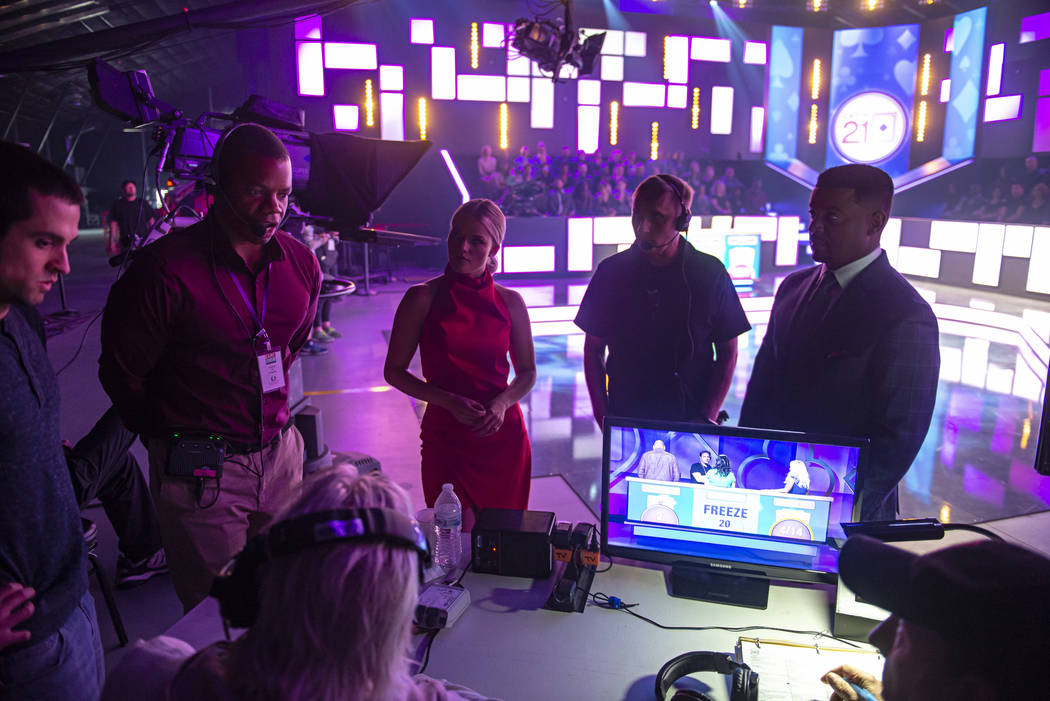 Host Alfonso Ribeiro and dealer Witney Carson discusses the game show "Catch 21" during a break ...