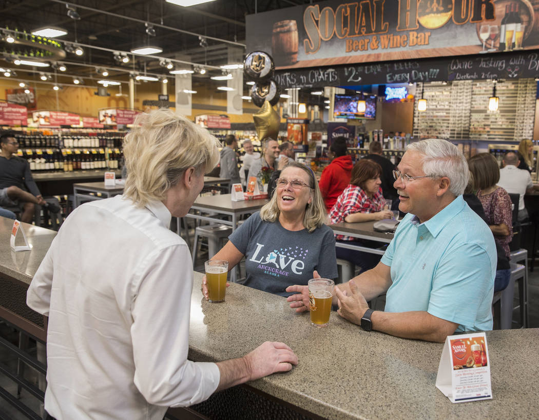 Wine steward Bradley Pugh, left, talks with Ron and Deb Crowl, from Anchorage, AK., at Social H ...