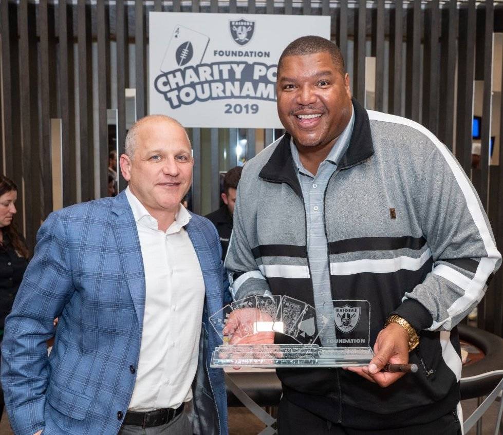 Raiders President Marc Badain and ex-Raider great Lincoln Kennedy are shown on the scene at the ...