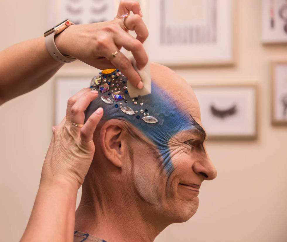 Performer and coach Didier Antoine gets his makeup applied to play the role of Morpheus before ...