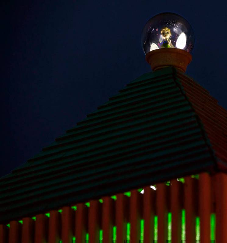 Tinkerbell sits atop a clock tower as part of the holiday lights display in the yard of Maria A ...