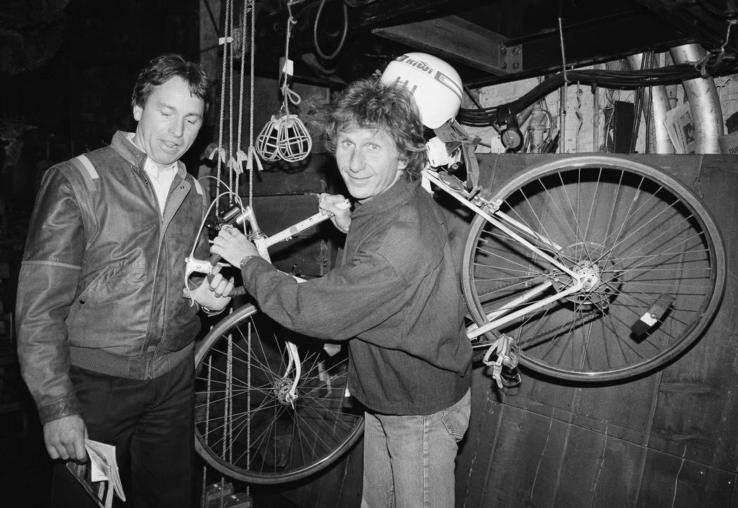 FILE - In this May 16, 1985, file photo, actor John Ritter, left, checks out the bicycle of fel ...