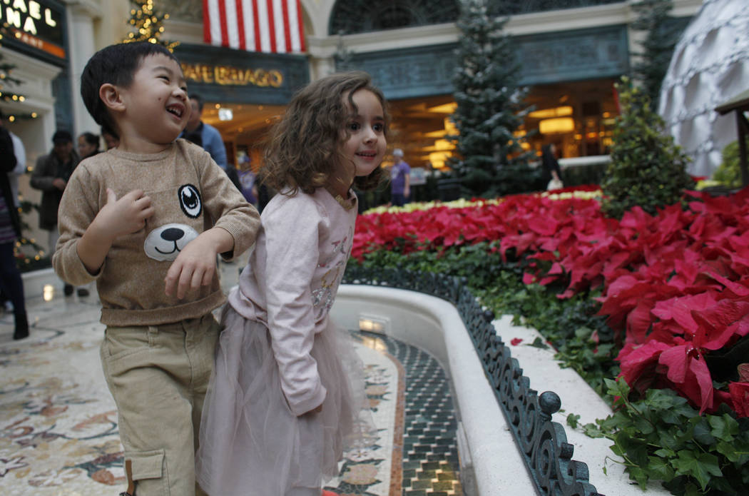 Alden Sutheno, 3, and Tala Taherzadeh, 3, wait for the toy train at the Bellagio Conservatory & ...