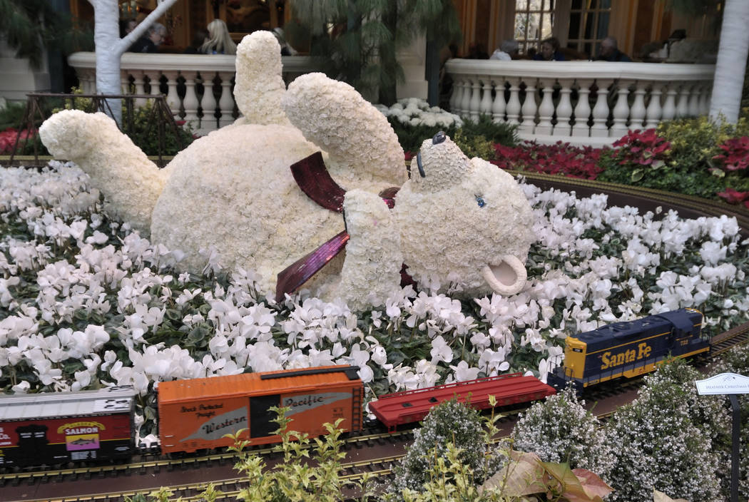 A baby polar bear sculpture, created using white carnations to make up its snowy coat, is displ ...