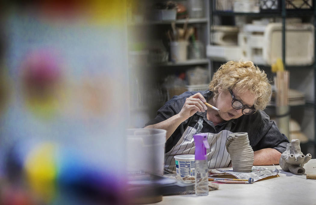 Julie Hopkins, who is legally blind, works on a piece of collaborative art on Thursday, Dec. 12 ...