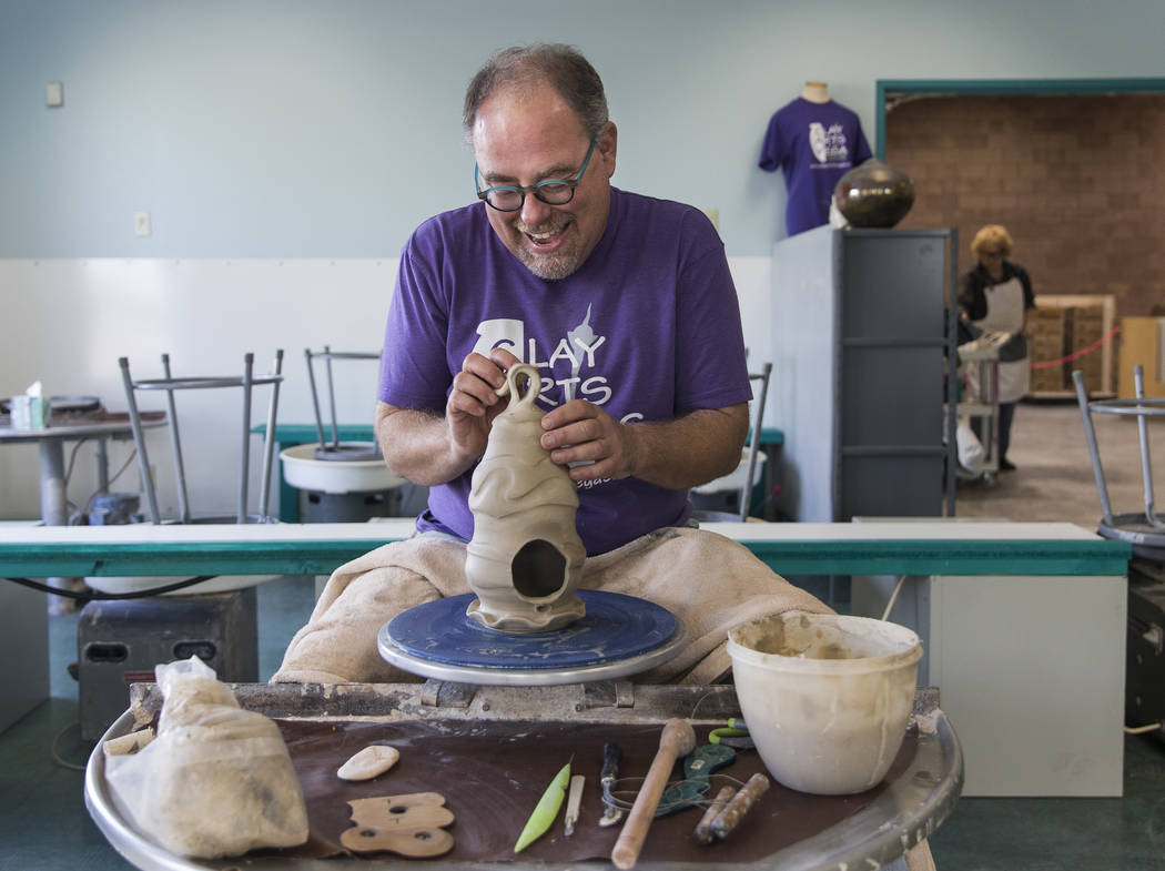 Thomas Bumblauskas, co-owner of Clay Arts Vegas, works on the wheel at the newly opened studio ...