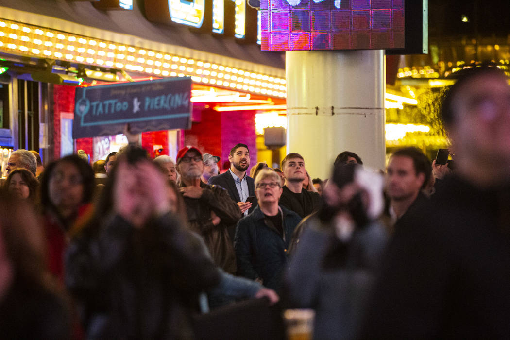 People watch the recently-upgraded Viva Vision screen as a video highlighting The Killers is pl ...