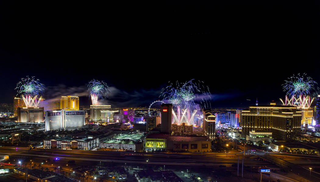 Fireworks for New Year's Eve erupt over the Strip as viewed from the VooDoo Rooftop Nightclub & ...