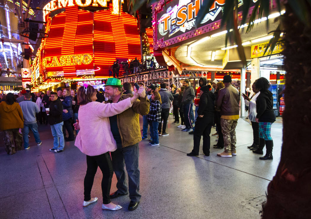 Sherry Schneider, left, of South Carolina, dances with Rob Schneider as New Year's Eve revelers ...