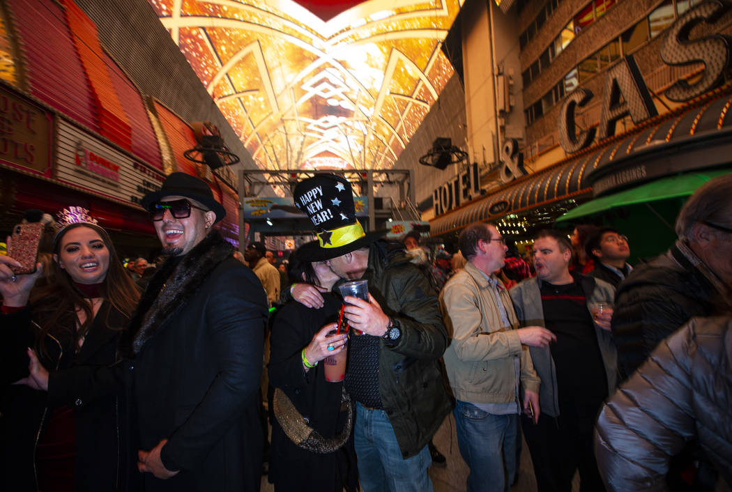 Revelers, including Karrie Wagner and James Green, of Dallas, center, celebrate during a New Ye ...