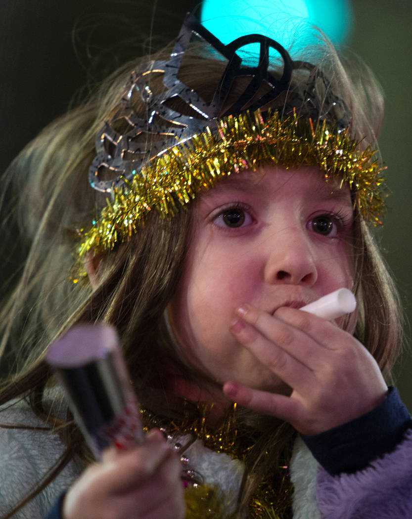 A girl blows a New Year's Eve kazoo on the Strip on Wednesday, Jan. 1, 2020, in Las Vegas. (Ell ...
